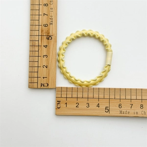 Detailed size measurement of pale yellow high-elasticity hair tie showing 5cm outer diameter