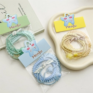 Three-piece pastel hair tie set with ruffle textures and beads in mint, blue, and yellow