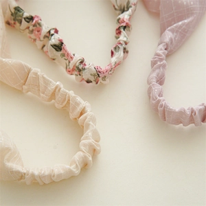 Detailed close-up of floral and sequined elastic headbands showcasing fabric texture