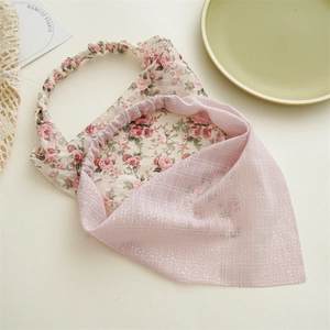 Detail of floral headscarf and pink mesh hairband with silver glitter and elastic band