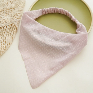 Detail view of light pink plaid headband with glitter sequins and elastic back band