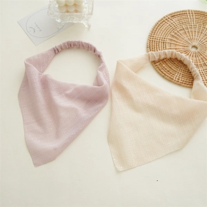 Detailed view of pink and beige headwraps with shimmering silver threads and elastic bands