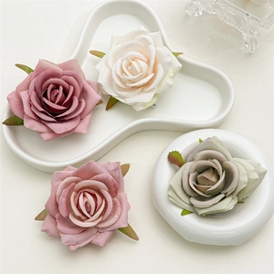 Detailed close-up of artificial fabric silk rose flowers in assorted pastel colors