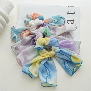 Detailed macro shot of macaron tie-dye chiffon bow scrunchies with long ribbons