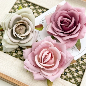 Romantic artificial rose hair clips in vintage pink and green tones for summer styling