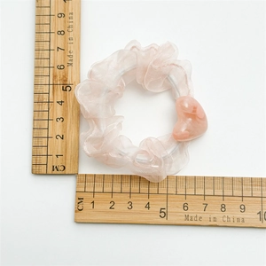 Pink heart mesh hair scrunchie shown with wooden ruler measurement on white background