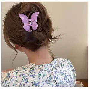 Vue de dos d'une femme portant une pince à cheveux papillon violette brillante