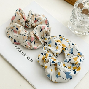 Close-up of floral print scrunchies showing soft fabric texture and elastic design