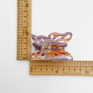 Top view of large hollow butterfly hair claw in purple and orange showing 8.5cm size