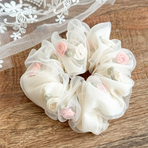 French style white organza hair scrunchie with pink 3D rose flowers on wood surface