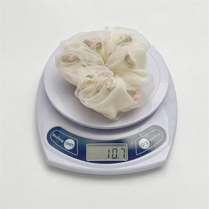 French style organza rose scrunchie in cream white weighing 10.7g on a scale