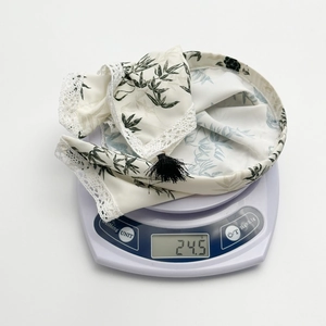 Close-up of lightweight ink-wash style headband showing weight of 24.5g and lace detail