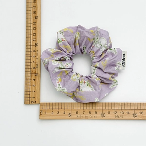 Floral print scrunchie in light purple fabric with size measurement scale shown