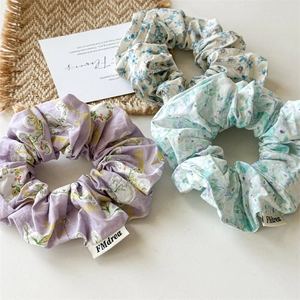 Three-piece floral fabric scrunchie set in purple, blue and mint green with FMdrea labels