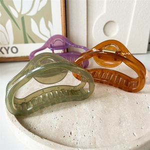 Three-piece large curved jelly cloud hair claw clips in green, amber, and purple hues