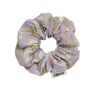 Pastoral lavender floral scrunchie with bird and leaf patterns and logo tag