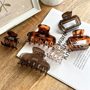 Minimalist coffee brown resin hair claw clips set in various sizes and amber tortoise patterns