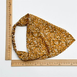 Detailed view of yellow floral cotton head scarf with elastic band measuring 25cm width