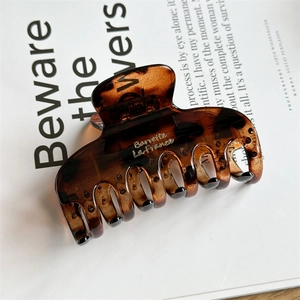 Close-up of brown tortoiseshell hair claw clip with gold Barrette La France lettering
