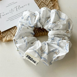 Floral fabric scrunchie with blue checkered pattern and rabbit motif in white