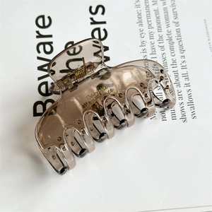 Detail of translucent brown resin hair claw with golden Barrette La France inscription