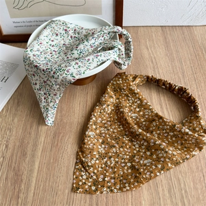 Close-up of floral elastic headbands in cream and yellow colors with soft fabric texture