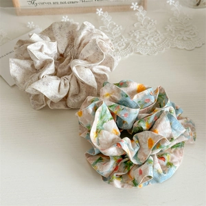 Close-up of handmade floral fabric scrunchies with elegant pleats and soft texture