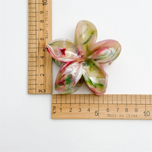 Pink and green marble flower hair claw clip shown with ruler for 5.5cm size reference