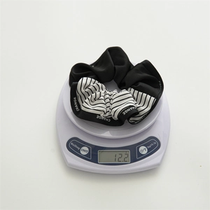 Large nautical style scrunchie with stripes and CHANGE letter print on a digital scale