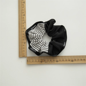 Detail view of large navy-style scrunchie with CHANGE print and 11cm size measurement