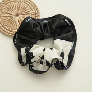 Detail of nautical style scrunchie with floral print and CHANGE letter border decoration