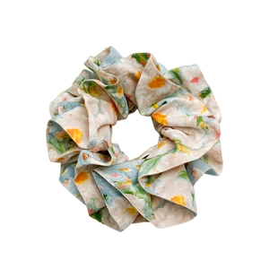 Floral print oversized scrunchie hair tie with light blue and orange summer fabric patterns