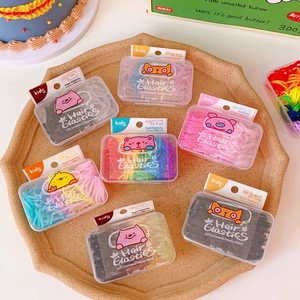 Detailed view of colorful elastic hair ties in cute cartoon animal storage boxes