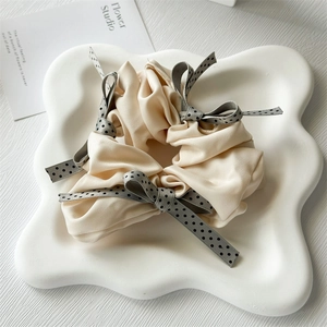 French style polka dot bow scrunchie in cream satin fabric with elegant silk texture