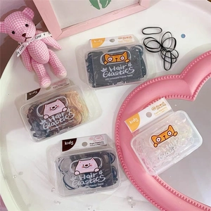 Detailed view of four boxes of colorful high-elastic hair ties for kids in pastel tones