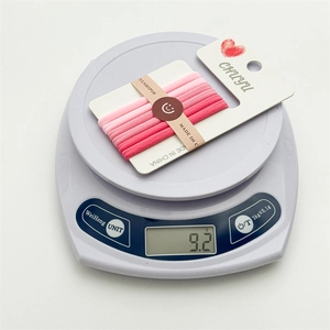 Detailed scale view of 10-piece seamless pink gradient hair ties weighing 9.2g