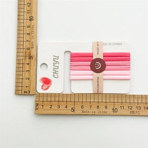 Set of 6 seamless high elasticity pink hair ties shown with measurement scale ruler