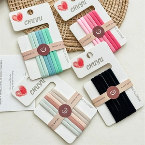 Set of 5 high-elastic seamless hair ties in gradient colors on a neutral woven mat