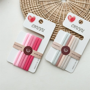 Close-up of seamless high-elasticity hair ties in pink and Morandi tones on a card