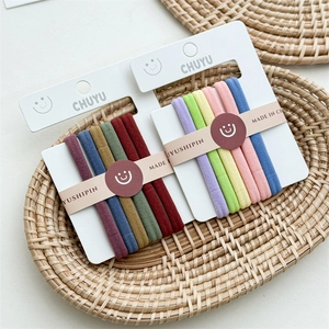 Close-up of colorful high-elastic seamless hair ties set in a woven rattan tray