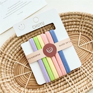 Detail of multi-colored pastel elastic hair bands set in a woven basket arrangement