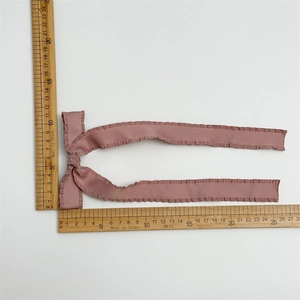 Dusty rose pleated chiffon bow hair clip shown with measurement ruler on white background