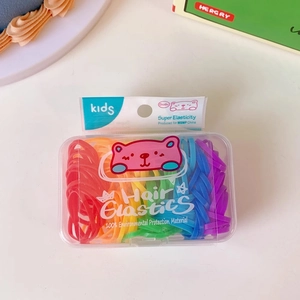 Close-up of assorted colorful jelly-colored hair elastics in a transparent storage box