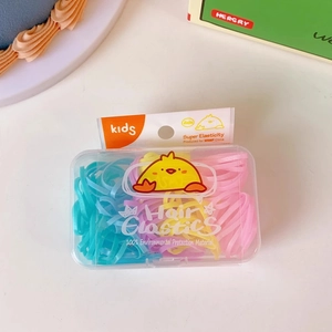 Macro shot of colorful hair elastics in a transparent box with cute cartoon graphics