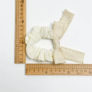 Off-white pleated satin hair scrunchie with long bow and ruffled edges measurement