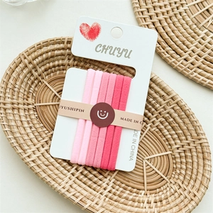Set of 6 pink seamless high-elastic hair ties displayed on a premium paper card