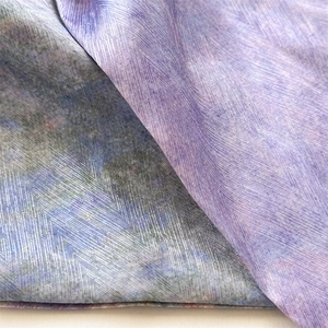 Detailed macro shot of violet gradient silk ribbon fabric texture with fine diagonal weave