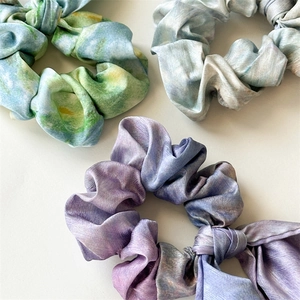 Detail of artistic oil painting style tie-dye hair scrunchies with silk texture ribbon