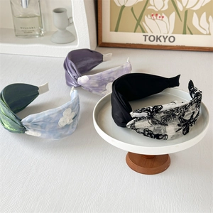 Detail of four floral wide headbands with cross-knot mesh and vintage sweet patterns