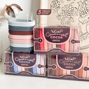 Close-up of seamless knit hair ties in caramel cocoa colors with ribbed texture and packaging